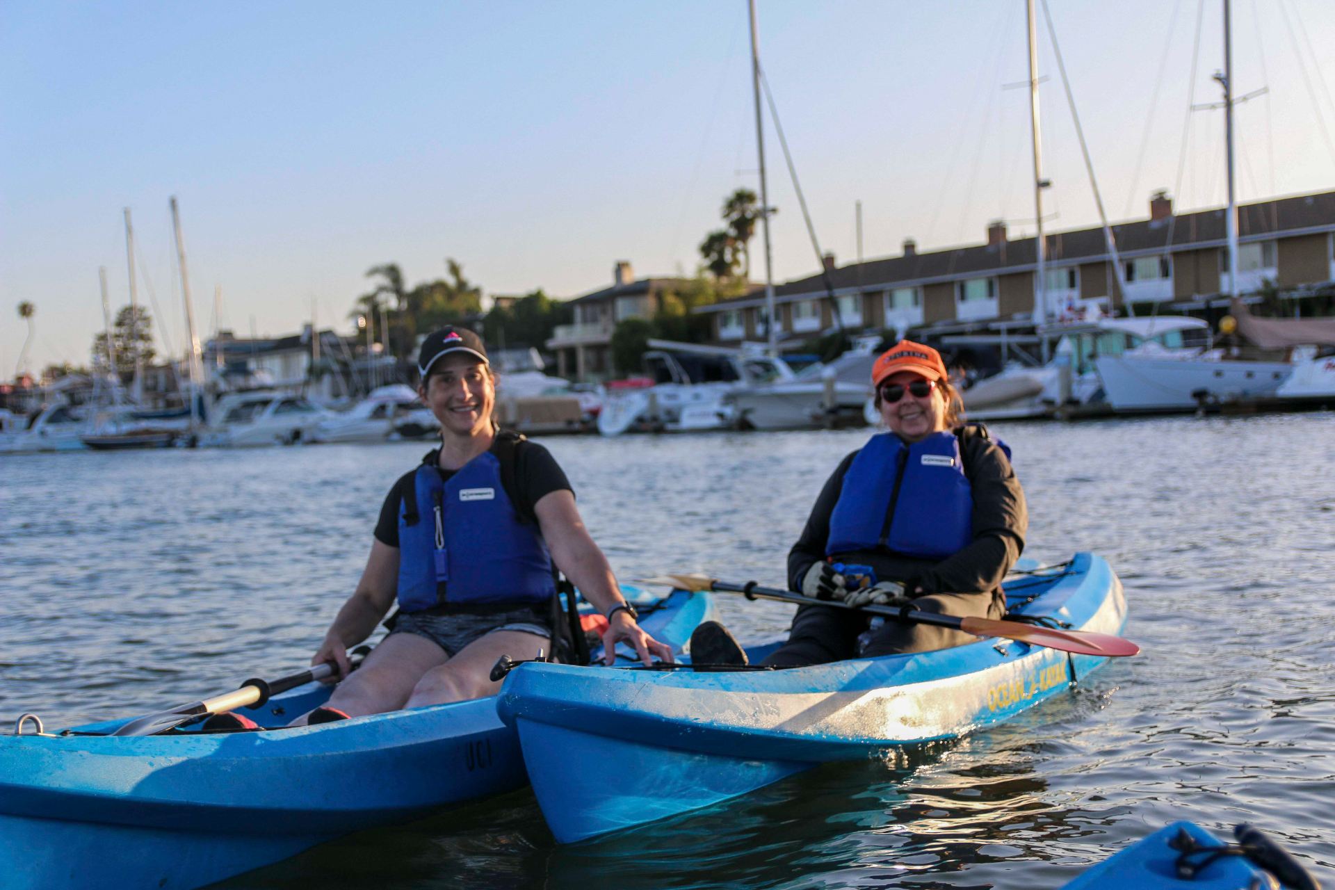 Two participants on a kayak smiling for a photo